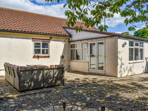 a detached house with a patio in front of it at The Barn in New Herrington