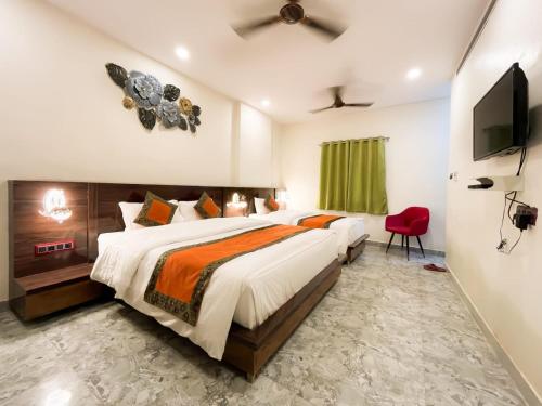 a bedroom with a large bed and a television at Namaste Benares Varanasi in Varanasi
