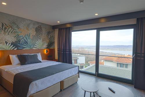 a bedroom with a bed and a large window at Best Western Plus Sapanca in Sapanca