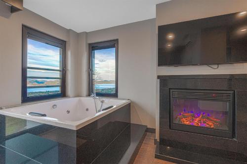 a bath tub in a bathroom with a fireplace at Best Western Plus Sapanca in Sapanca