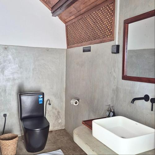 a bathroom with a sink and a bath tub at Tribe Wilpattu - Eco Lodge in Wilpattu