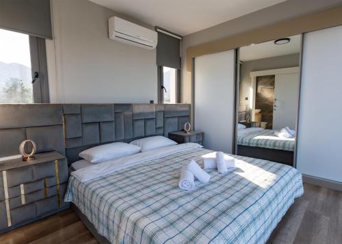 a bedroom with a large bed with two pillows at Delux SeaSide Victorious Villa by HolidayKeys in Kyrenia