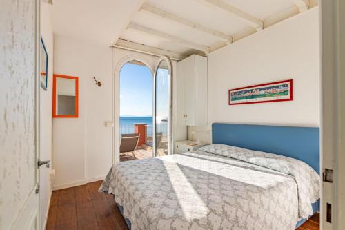 a bedroom with a bed and a view of the ocean at Villino Gelli in Follonica