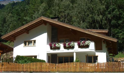 ein weißes Haus mit Blumenkästen drauf in der Unterkunft Ferienwohnungen Eiter Fridolin in Zaunhof