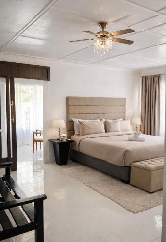 a bedroom with a bed and a ceiling fan at La Dukes Resort in Bushman Rock