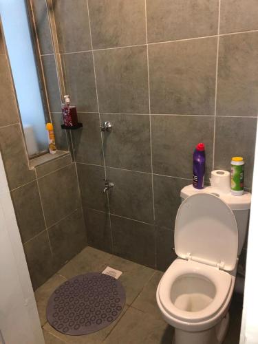 a bathroom with a toilet and a shower at Thesh Home at Tsavo Sunset 2 ,Thindigua Kiambu Road in Kiambu