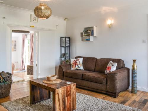 a living room with a couch and a table at The Barn in New Herrington