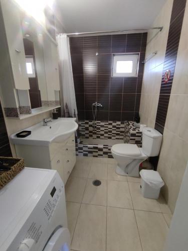 a bathroom with a toilet and a sink at Kritharia Guesthouse Volos in Kritharia