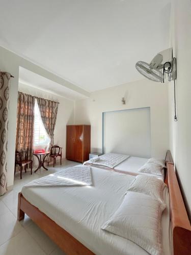 a bedroom with a large bed with a light above it at Nhà Minh Anh in Vung Tau