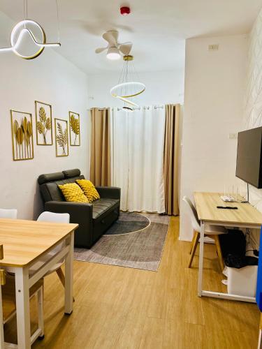 a living room with a couch and a table at Bayanihan Flats 2 in Mactan