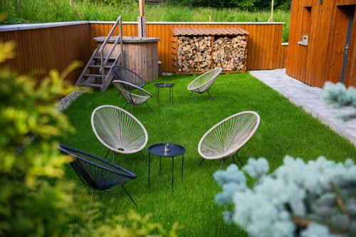a group of chairs and tables in a yard at Apartmány Na Satině in Malenovice