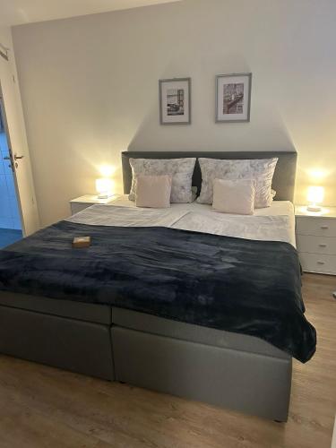 a bedroom with a large bed with two night stands at Warendorf 14 in Warendorf