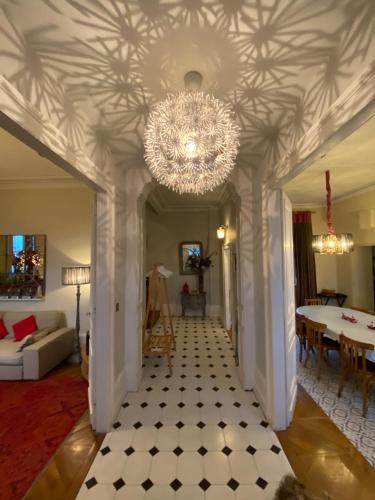 a living room with a chandelier hanging from a ceiling at Villa Theodora in Blois