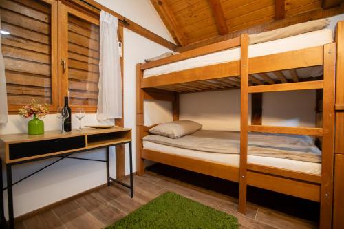 a bedroom with two bunk beds and a desk at Savoy Village in Čokadinci