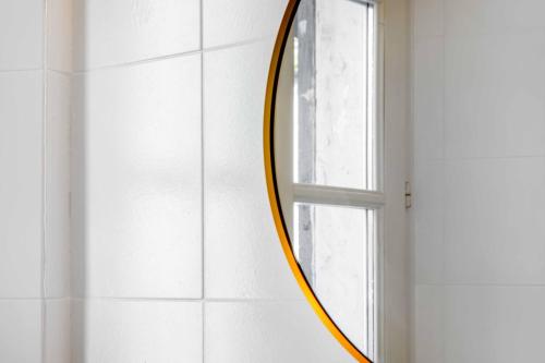a round mirror on a wall next to a window at Borgo Riccio - Nice place in Parma in Parma