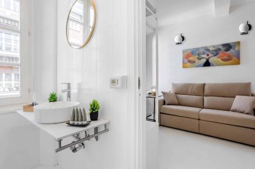 a white living room with a sink and a couch at Borgo Riccio - Nice place in Parma in Parma