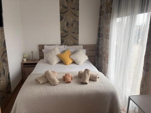 a bedroom with a bed with three pillows on it at Magnifique studio in Bressols