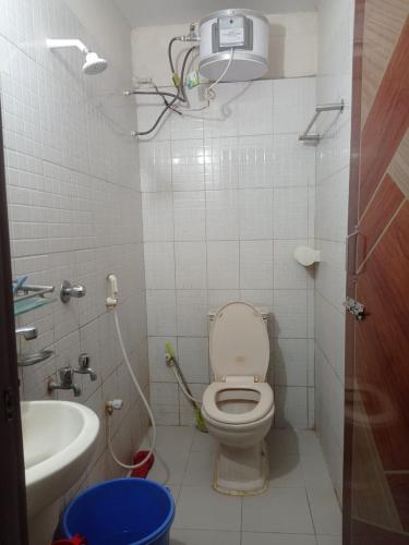 a small bathroom with a toilet and a sink at Hotel Sikder-02 Residential in Dhaka