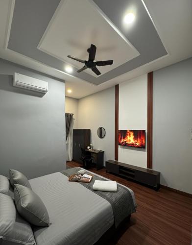 a bedroom with a bed and a ceiling fan at D'Anjung Cottage Paka in Paka