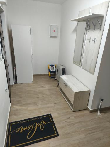 a room with a kitchen with a rug on the floor at Pantelej gates in Niš