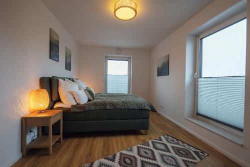 a living room with a couch and a window at Penthouse `Wolke 7` am See mit Sauna in Lembruch