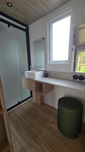 a bathroom with a sink and a large window at Mobil-home Harmonie in Gouvieux