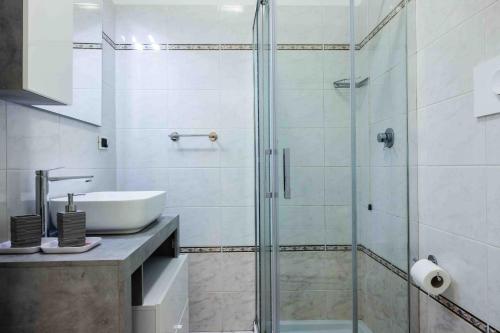a bathroom with a glass shower and a sink at Rio Apartment cà di Euro with parking in Riomaggiore