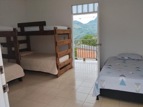 a bedroom with two bunk beds and a balcony at Apartamento Rústico Moderno in Ruiosucio