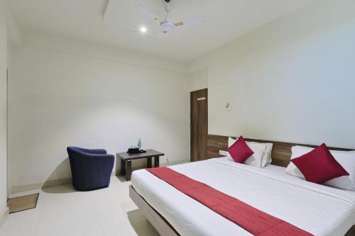 a bedroom with a large bed with red pillows at The Castle Crown - Hotel Scintilla, Somnath in Somnath