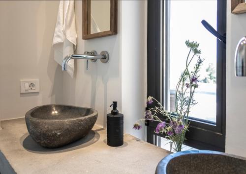 a bathroom with a bowl sink on a counter at Villa Anna in Paleros