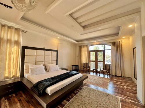 a bedroom with a large bed in a room at The Landing Nest - Villa in Srinagar