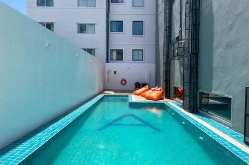 a swimming pool in the middle of a building at Citin Armoni Patong Hotel by Compass Hospitality - Newly Renovated in Patong Beach