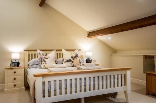 a bedroom with a bed with a crib at Rose Barn in Hawkshead