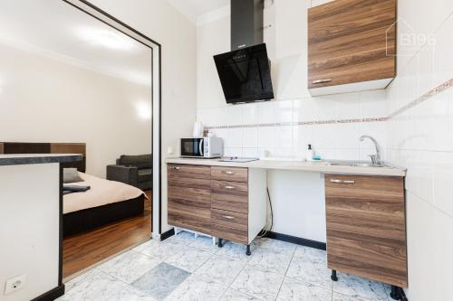 eine Küche mit Spüle und Mikrowelle in einem Zimmer in der Unterkunft ApartHotel Riga in Riga