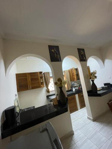 a kitchen with arches and a counter with vases at Mtwapa- North Coast in Mtwapa