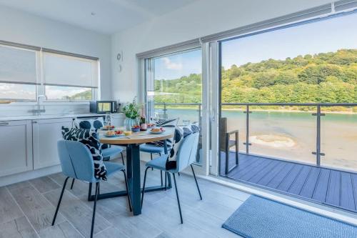 a kitchen and dining room with a table and chairs at River View - Prime River Front Location in Seaton