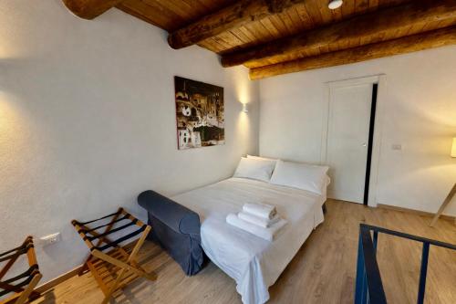 a bedroom with a bed in a room with a wooden ceiling at Lilla Stuga in Montenero Val Cocchiara