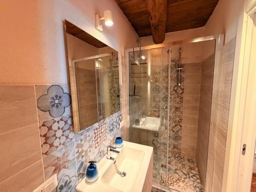 a bathroom with a sink and a shower at Lilla Stuga in Montenero Val Cocchiara