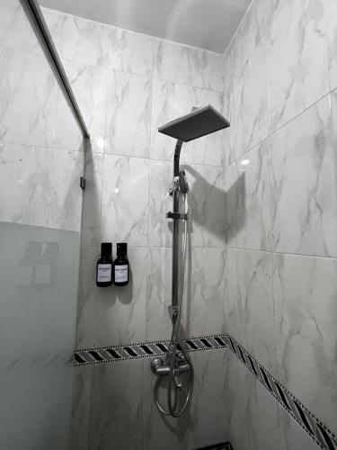 a shower in a bathroom with white marble walls at Cabo Dream 71 in Cabo Negro