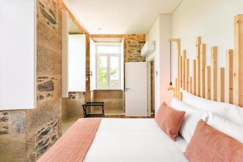 a bedroom with a large bed and a window at Casa da Lameira Douro Valley in Peso da Régua