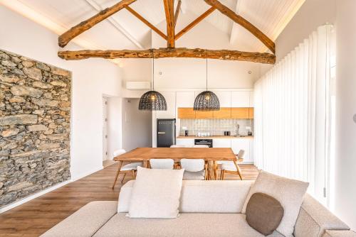 a kitchen and dining room with a wooden table and chairs at Casa da Lameira Douro Valley in Peso da Régua