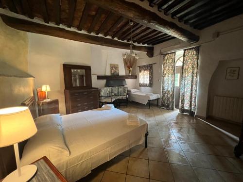 a bedroom with a bed and a living room at LA GRANCIA DEL SANTO in Monticiano
