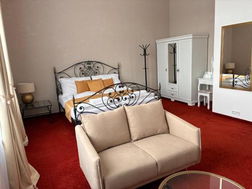 a living room with a bed and a couch at Vila Černý leknín in Tábor