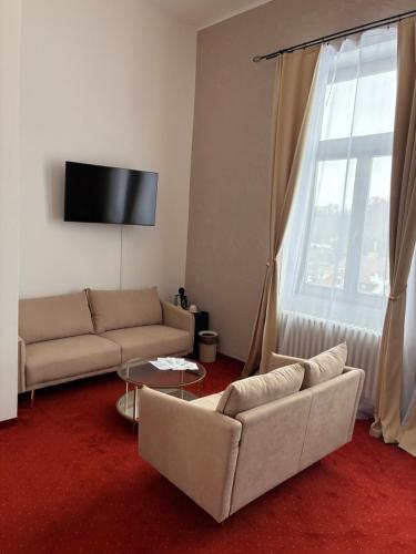 a living room with a couch and a window at Vila Černý leknín in Tábor