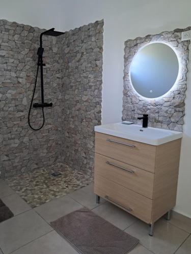a bathroom with a sink and a mirror at Villas Sarique in Grand-Bourg