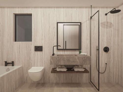 a bathroom with a sink and a toilet and a mirror at Filion Suites Resort & Spa in Bali