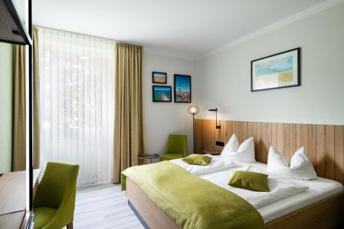 a hotel room with a bed and a window at Atrium Hotel Krüger in Rostock
