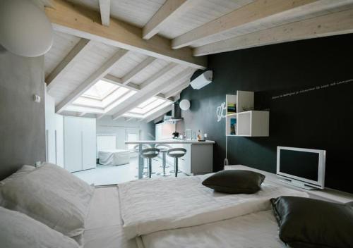 a bedroom with a large bed and a table in it at Casa Felice by Villa Porta Collection in Luino