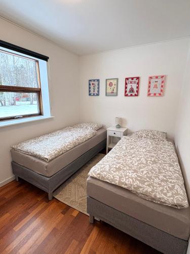 two twin beds in a bedroom with a window at K&V Apartments Billund Near Legoland #1 in Billund