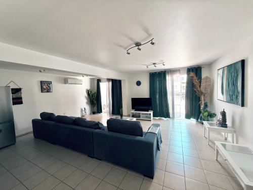 a large living room with a couch and a table at Kapparis Pleasure Familly Lounge in Paralimni